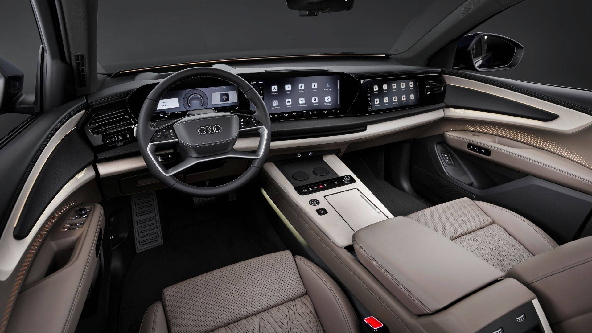 Audi Q9 luxury SUV cabin with digital dashboard screens, steering wheel, center console, ambient lighting, and beige leather seats.