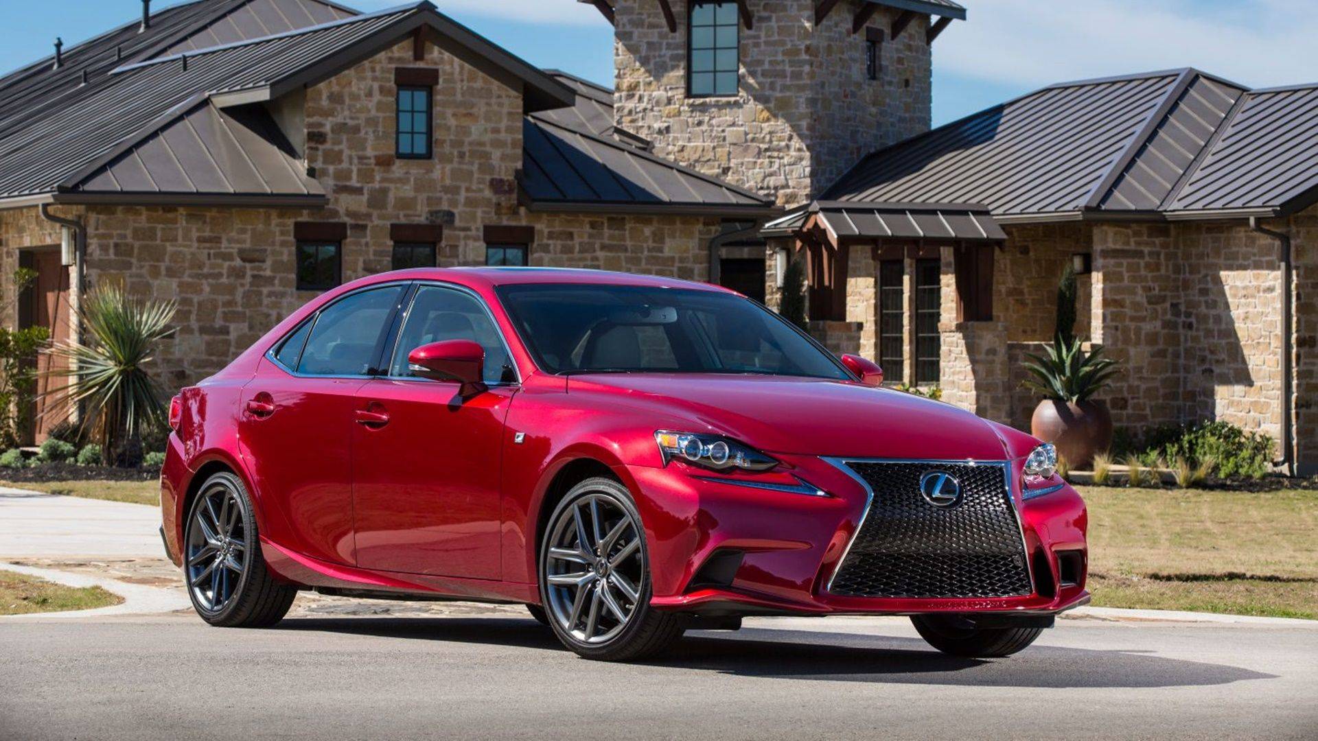 Red 2014 Lexus IS 350 driving on a track