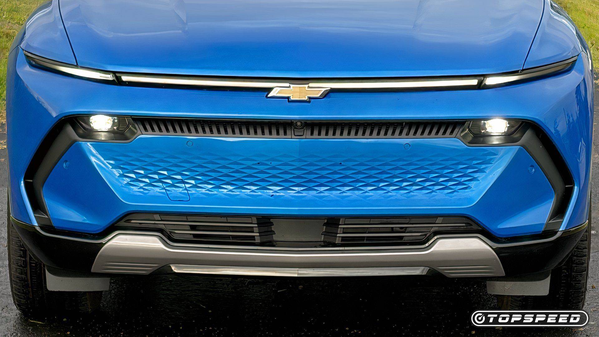 Close-up front view of a blue Chevrolet Equinox EV with LED light bar and Chevrolet emblem.