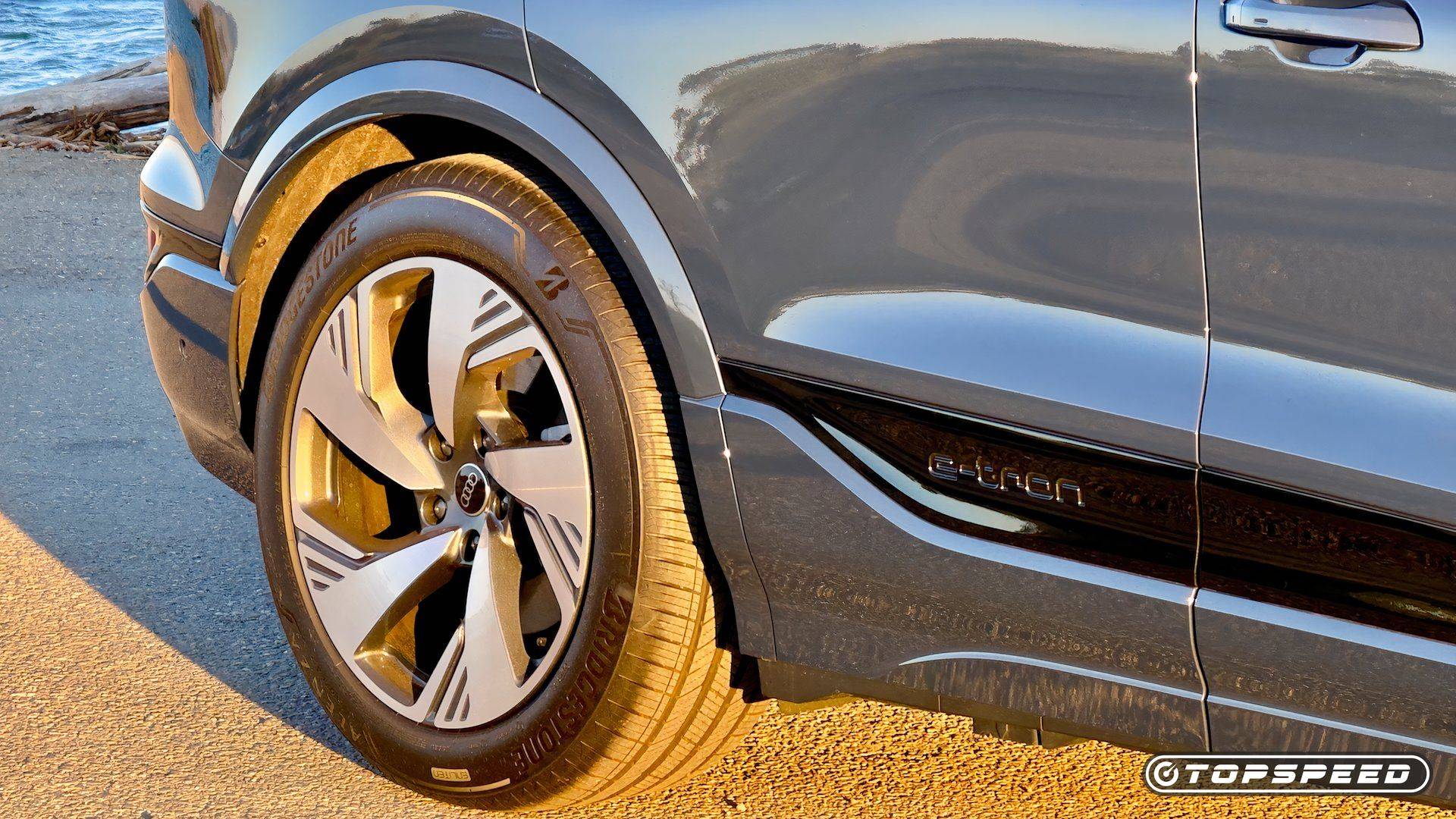 Close-up of an Audi Q6 e-tron wheel, side panel, and e-tron door trim
