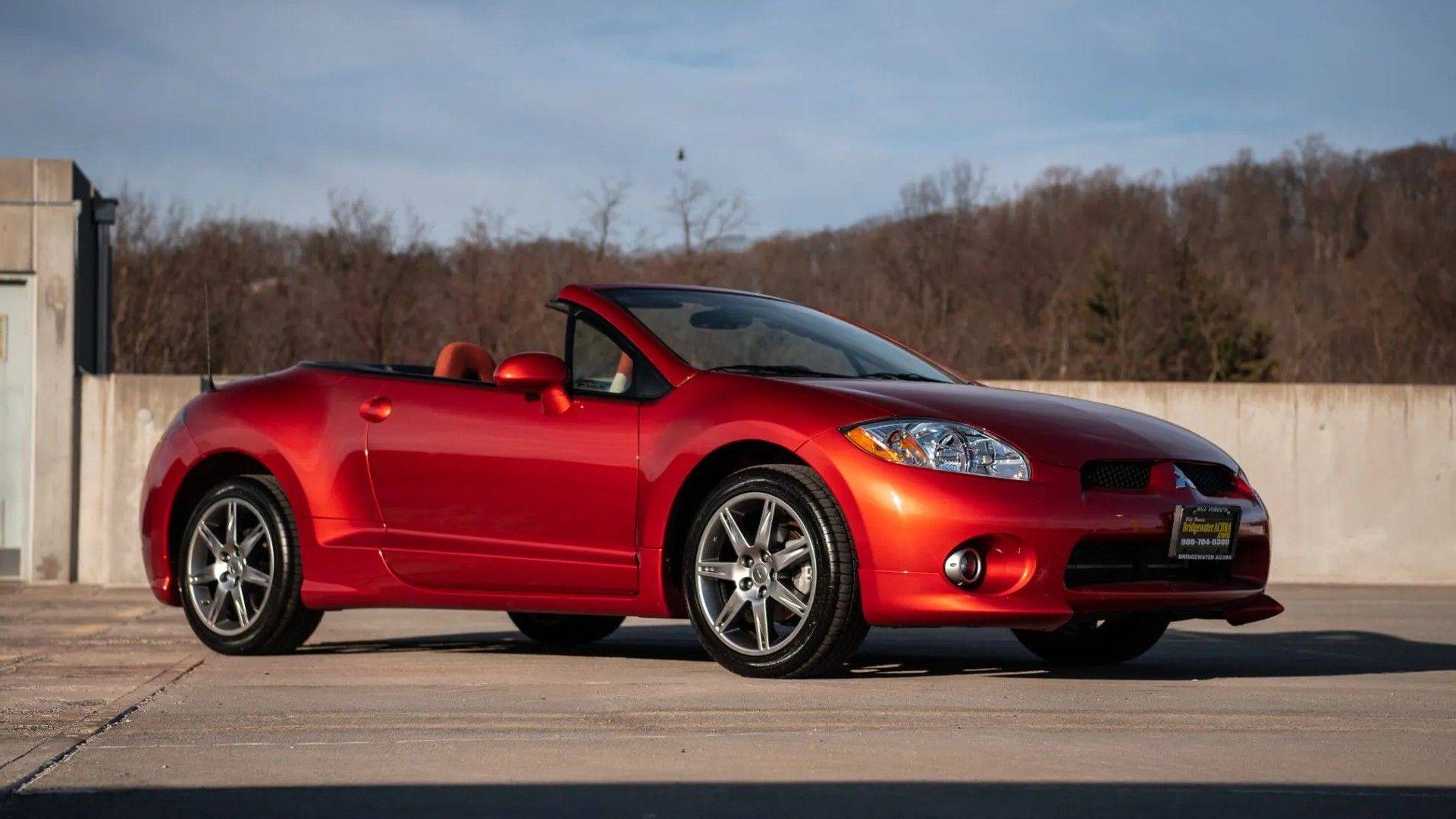 Red 2008 Mitsubishi Eclipse GT Spyder convertible from the front three-quarter angle