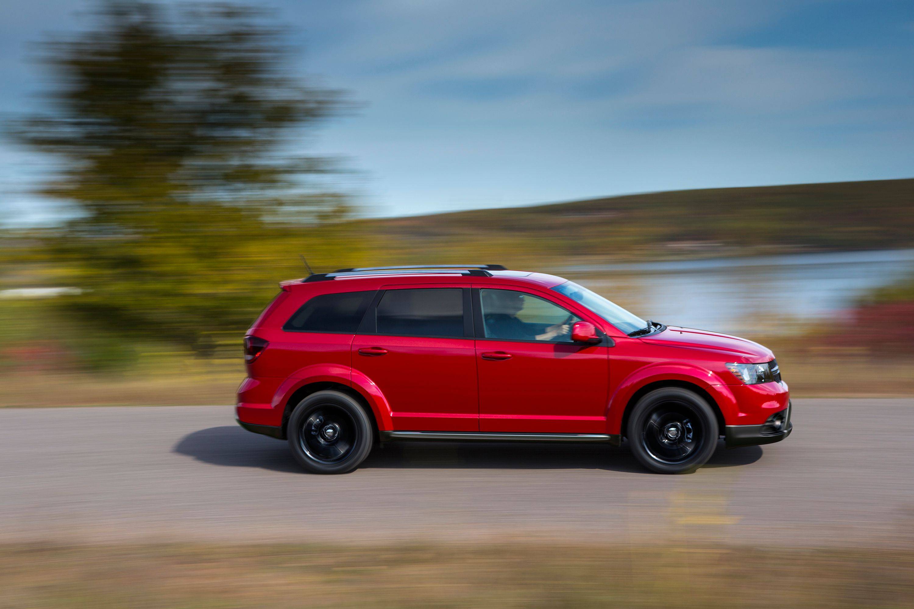 Front view of a red 2018 Dodge Journey on a grassy trail