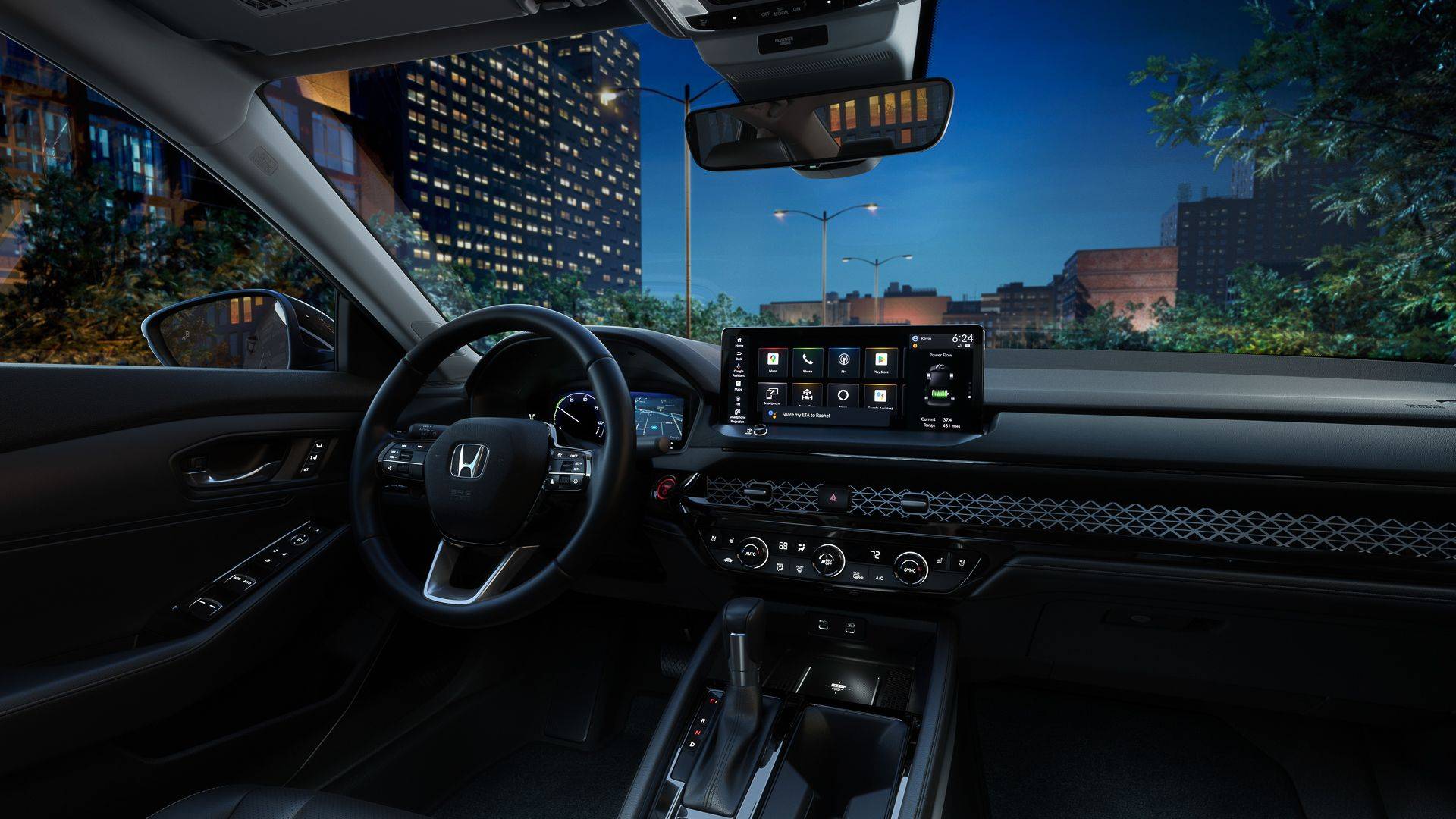 Honda Accord interior at night with steering wheel, dashboard touchscreen, and city buildings visible outside.