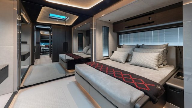 BRABUS Big Boy 1200 bedroom with a large bed, quilted pillows, mirrored wardrobe, and ambient lighting