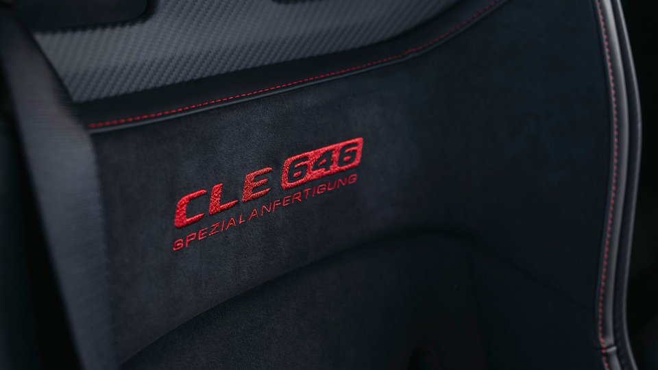 Close-up of CLE 646 Spezialanfertigung embroidery on black seat upholstery with red stitching