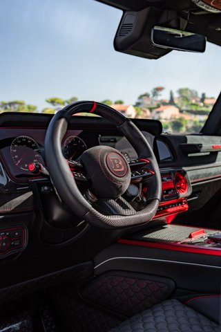 Brabus-branded steering wheel, instruments and red-accented dashboard