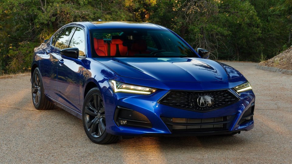 Blue Acura TLX A-Spec with illuminated headlights