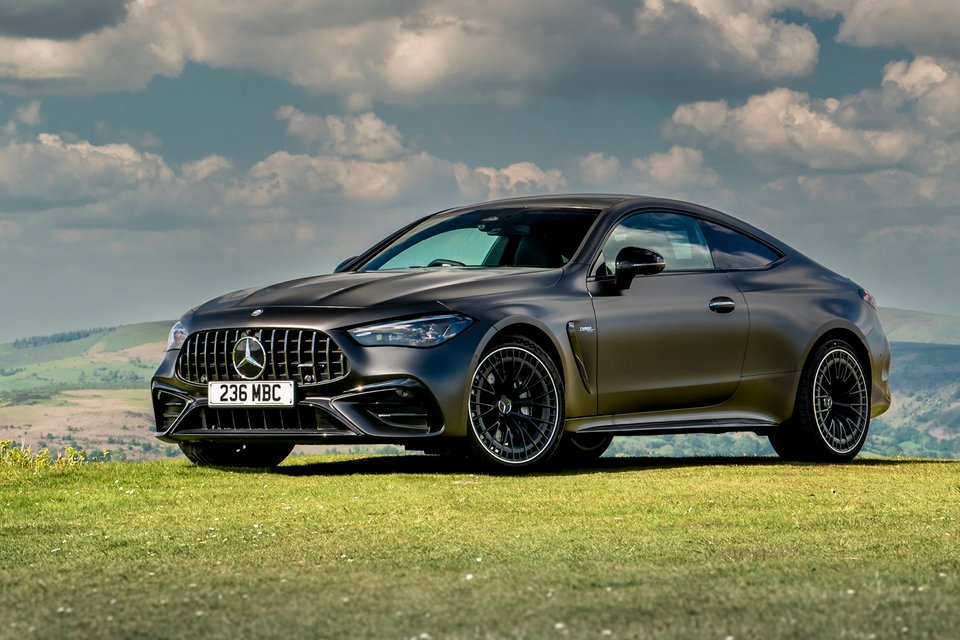 Black Mercedes-AMG CLE 53 coupe parked on a grassy hill