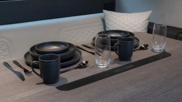 BRABUS Big Boy 1200 dining table set with black tableware and quilted white seating
