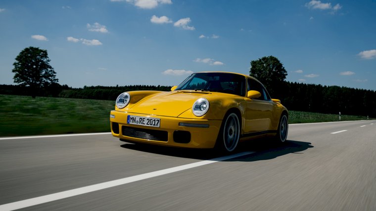 Yellow RUF CTR Anniversary driving on a country road