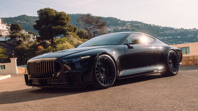 Black BRABUS BODO luxury coupe beside a wooded hillside