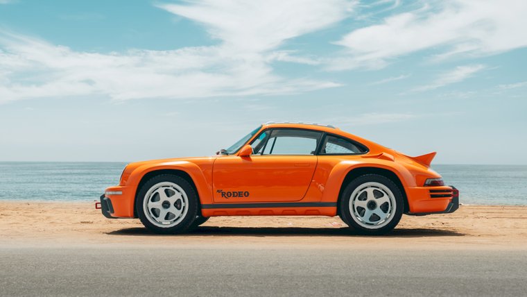 Orange RUF Rodeo beside the beach