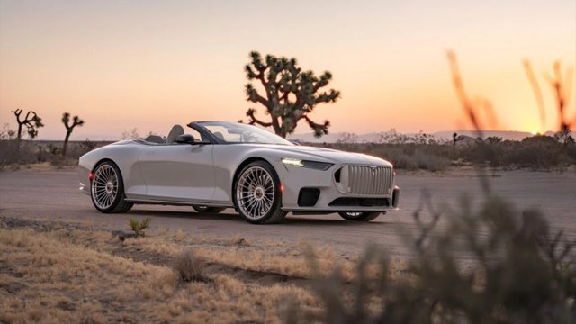 White BRABUS BODO Cabriolet with its roof down on a desert road at sunset