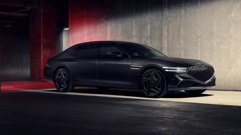Black Genesis G90 luxury sedan in an industrial parking structure