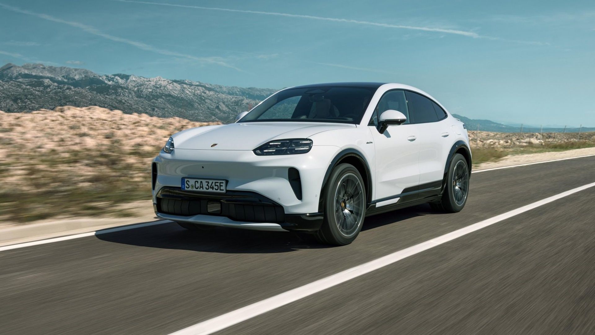 White Porsche Cayenne Coupé Electric driving on a mountain road