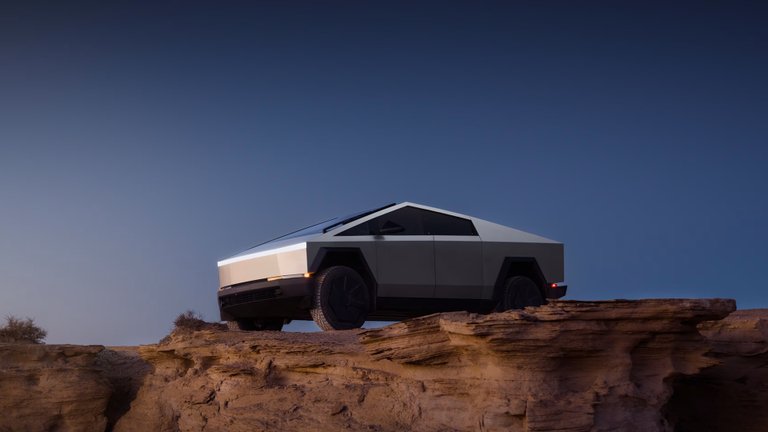 Tesla Cybertruck on sandstone terrain beneath an evening sky