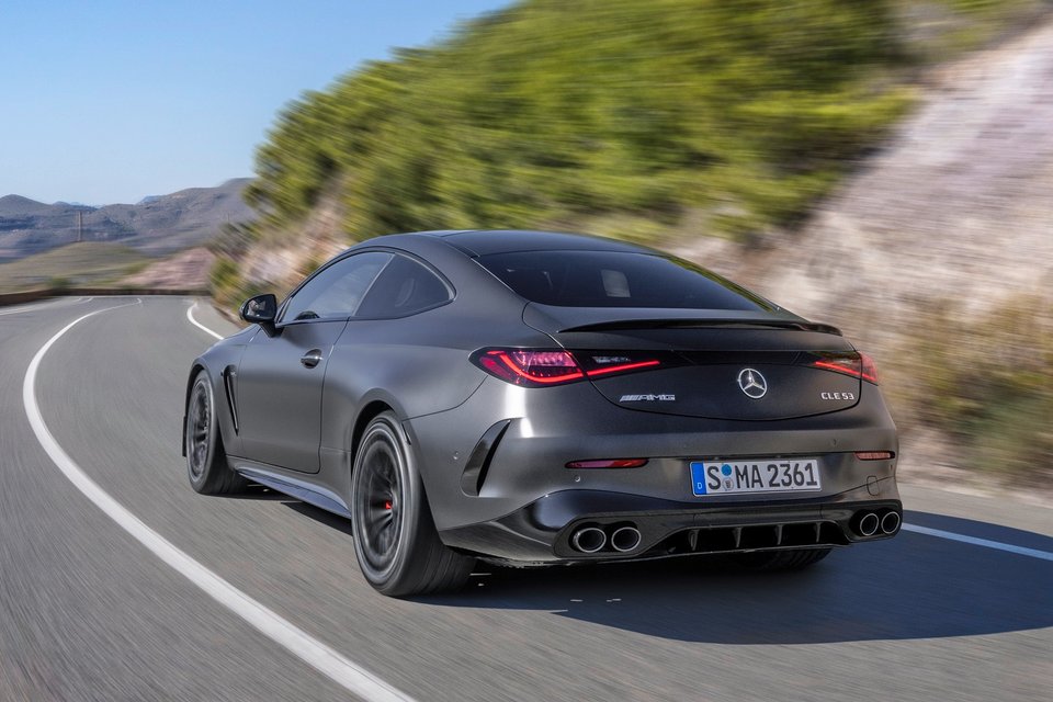 Gray Mercedes-AMG CLE 53 coupe driving on a winding mountain road