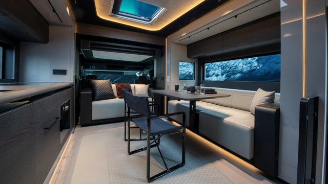 BRABUS Big Boy 1200 lounge with leather seating, dining table, kitchenette, and ambient lighting