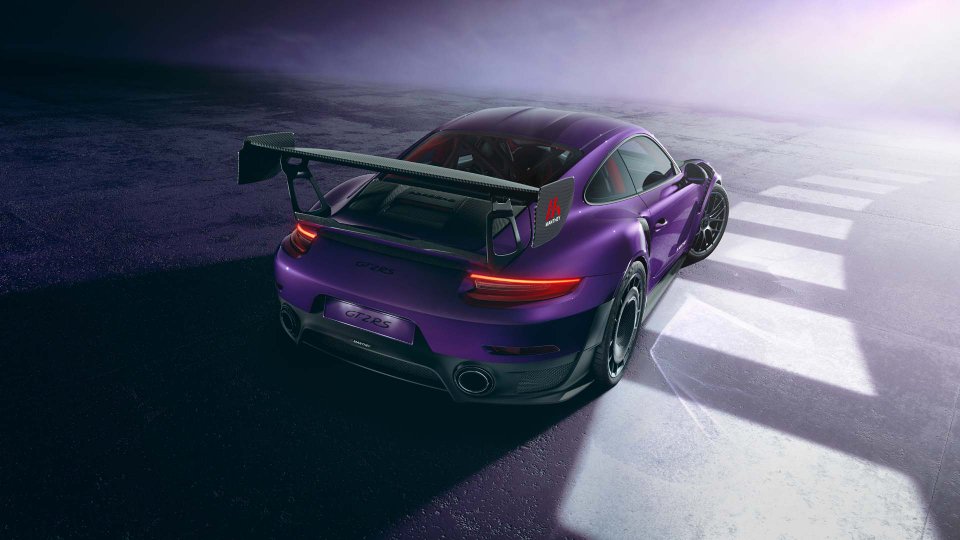 Purple Porsche 911 GT2 RS with a large Manthey rear wing in a dramatic studio