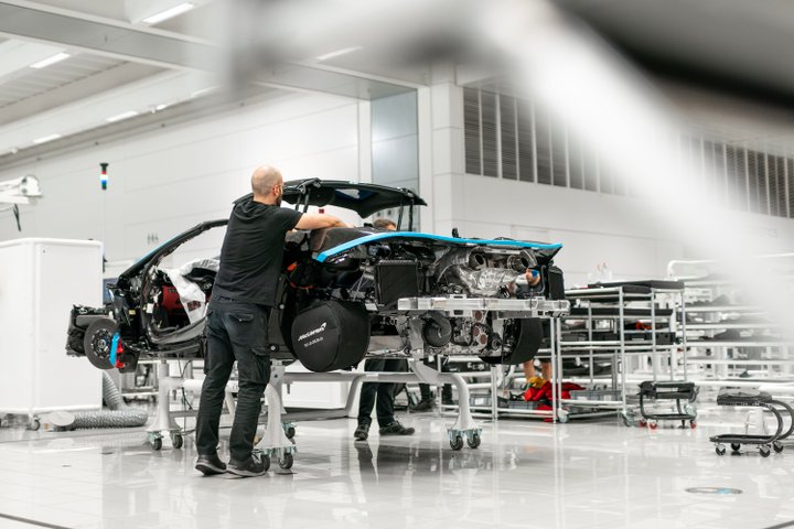 McLaren technician assembling a high-performance vehicle in the workshop