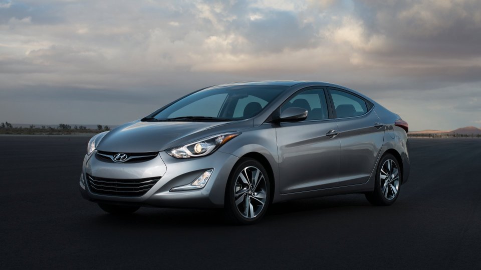 Silver Hyundai Elantra sedan beneath a cloudy sky