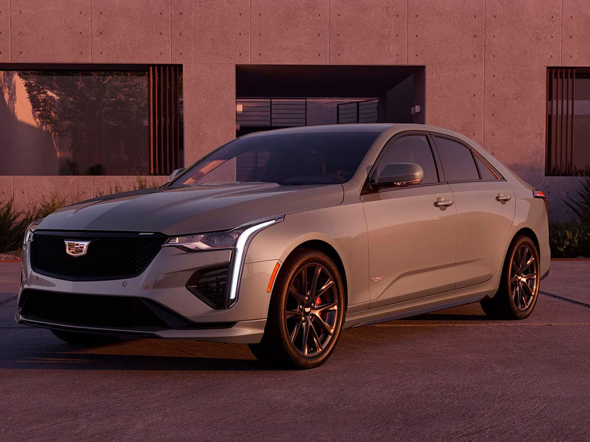 Cadillac CT4-V Blackwing parked outside a modern building at sunset