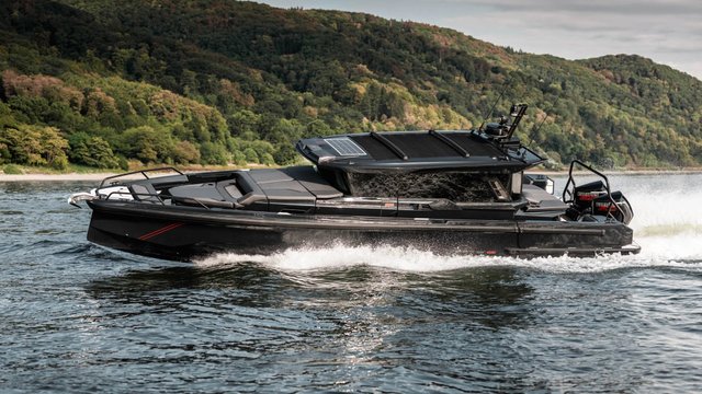 Black BRABUS Shadow 1000 XC Cross Cabin running with twin outboard engines