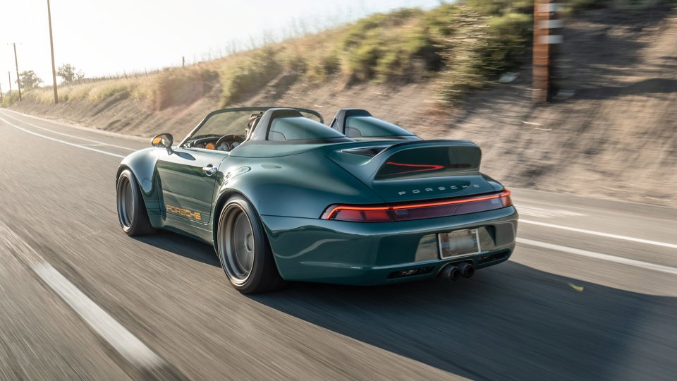 Dark green Gunther Werks Porsche 993 Speedster driving on a rural road
