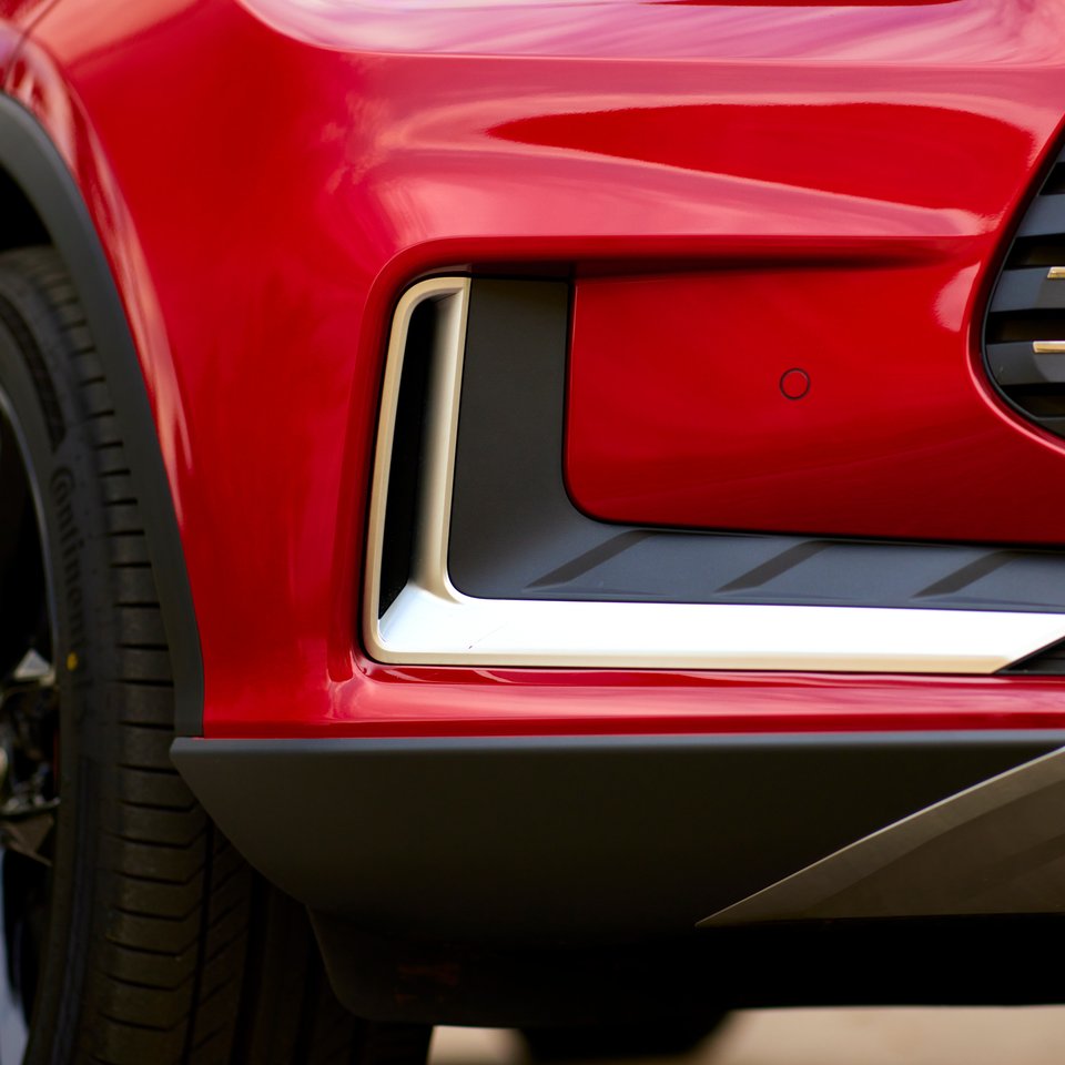 Front bumper and wheel-arch detail on a red BYD Tang