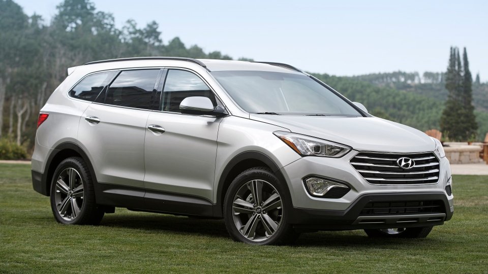 Silver Hyundai Santa Fe SUV parked on grass