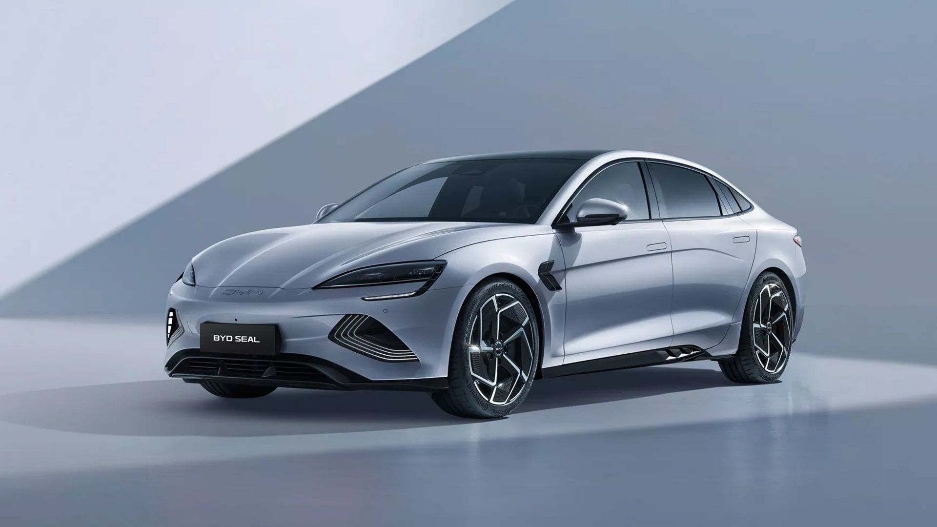Silver BYD Seal electric sedan in a studio setting