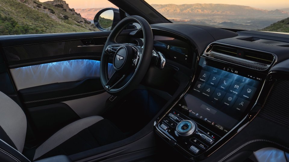 Bentley Torcal cockpit with touchscreen, carbon-fiber trim, and illuminated door panel
