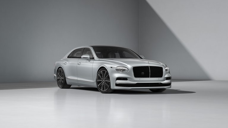 Silver Bentley Flying Spur shown in a studio