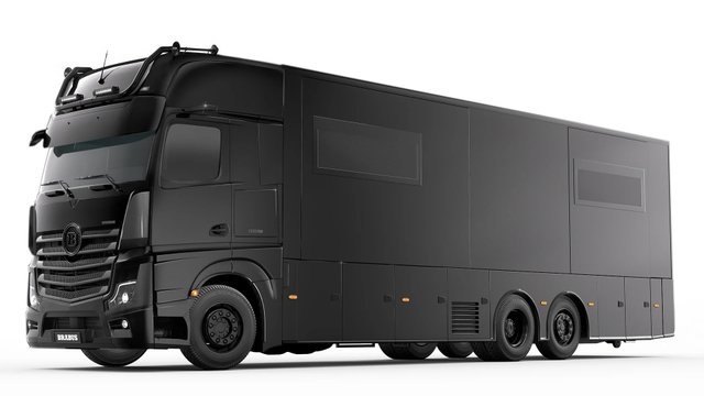 Black BRABUS Big Boy 1200 luxury motorhome with multiple rear axles in a studio