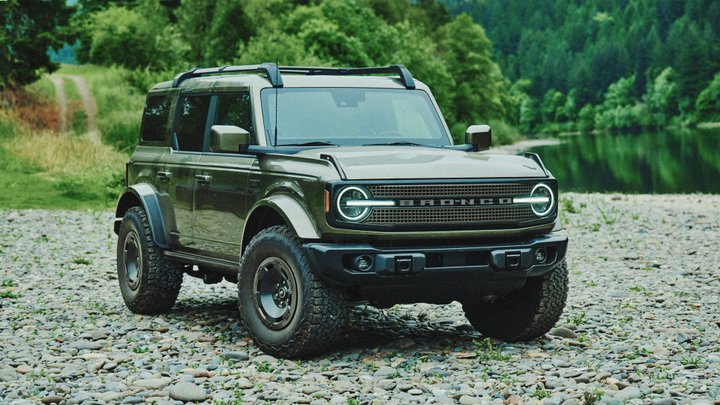 Dark green 2027 Ford Bronco Filson on a rocky riverbank