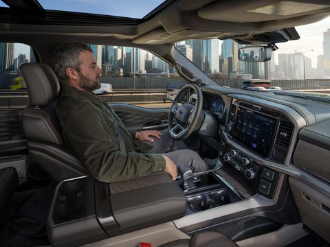 Ford F-150 driver using hands-free driving assistance with the dashboard touchscreen visible