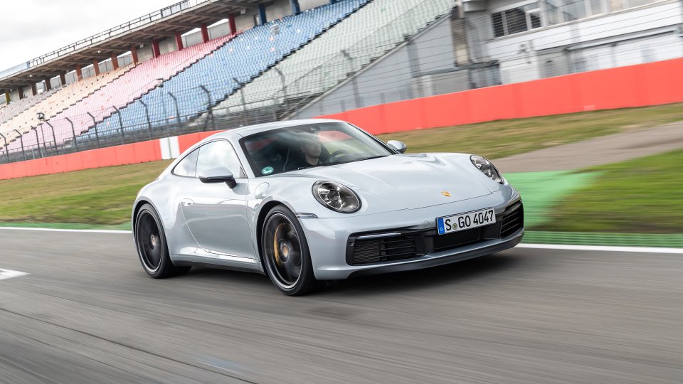 Silver Porsche 911 Carrera 4S driving on a racetrack